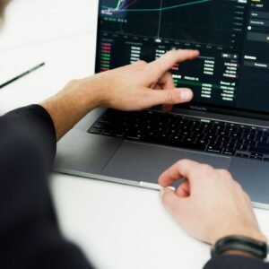 Business professional analyzing stock market trends on a laptop for financial planning.